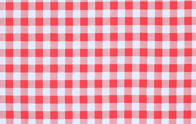 A red and white plaid tablecloth with a white background.