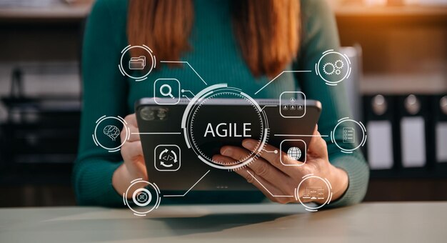 Agile development methodology concept Business hand using laptop and tablet with virtual screen Agile icon on modern office digital technology conceptxA