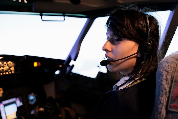 Aircrew copilot using power radar on dashboard to fly aircraft jet, pushing control panel lever and navigation command in cockpit cabin. Flying airplane with dashboard buttons and handle.