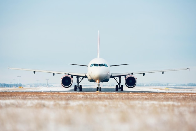Airplane on airport runway against clear blue sky