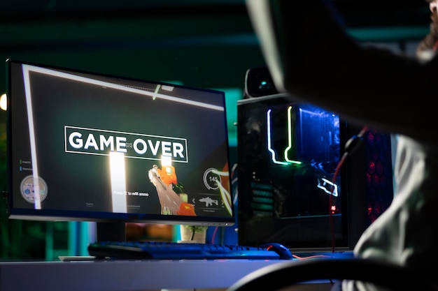 Annoyed man upset after losing while playing FPS videogame failing to win