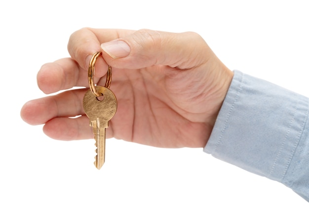 Apartment key in a man's hand. Brass house door lock key.