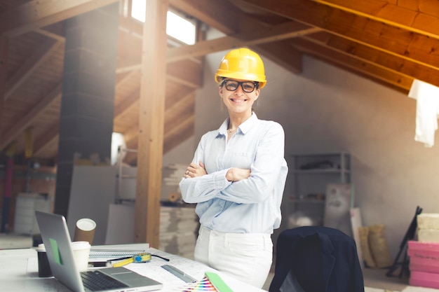Architect wearing hardhat while working at construction site