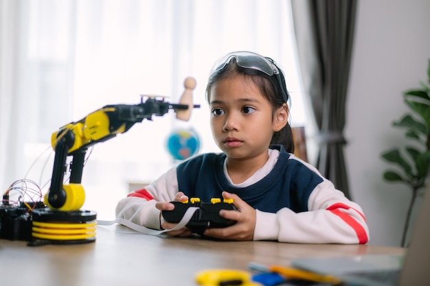 Asian girls were learning robot programming and getting lessons control on robot arms Laboratory Mathematics engineering science technology computer code coding STEM education