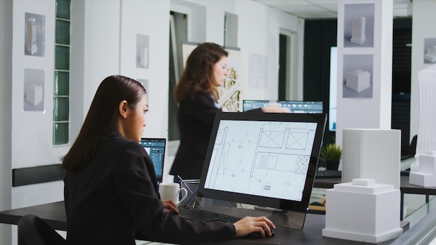 Asian graphic artist designing floor plan blueprint