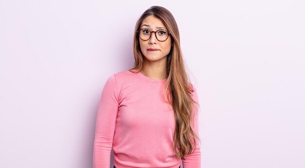 Asian pretty woman feeling clueless, confused and uncertain about which option to pick, trying to solve the problem