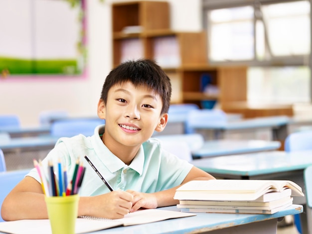 asian schoolboy studying in classroom