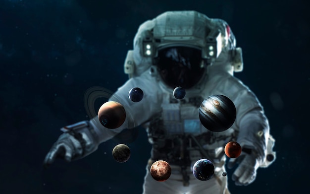 astronaut and the solar system. symbol of space exploration. elements of this image furnished by nasa