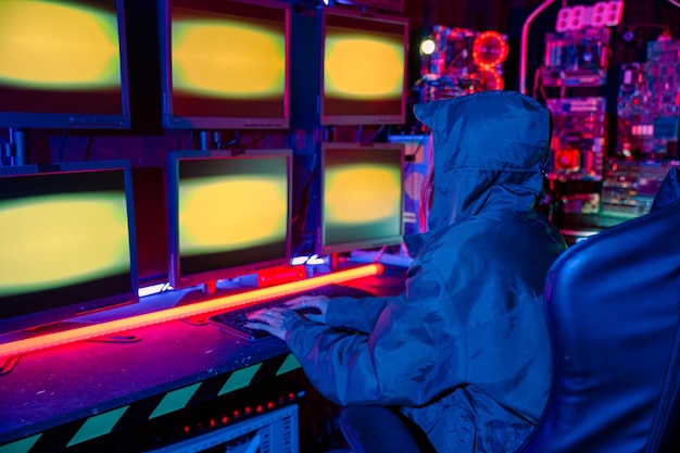 Back view of female hacker breaks into data center blockchain cyber attack woman hacker wear hood