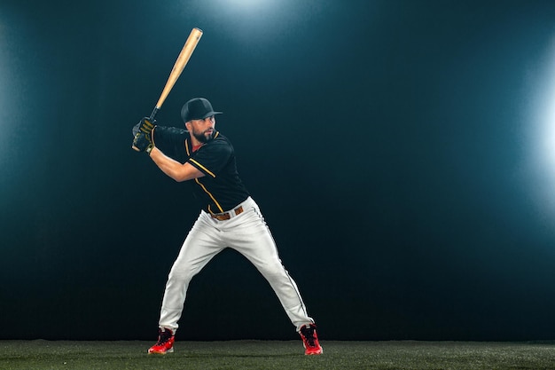 Baseball player with bat on dark background ballplayer portrait