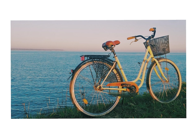Bicycle by sea against clear sky