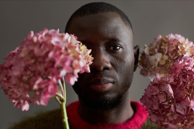 Black man with pink flowers