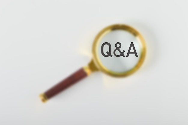 Blurred image of magnifying glass with text QA