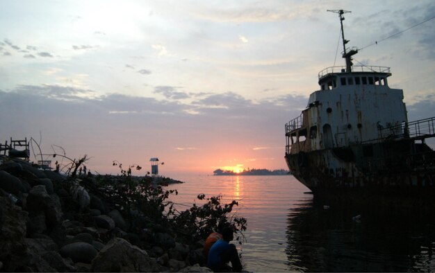 boat moored on sea against sky