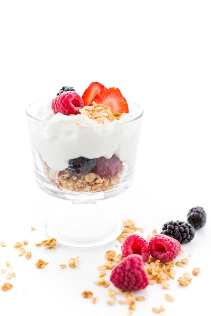 Breakfast parfait made from Greek yogurt and granola topped with fresh berries.