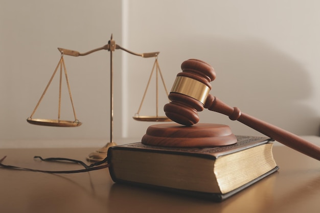 business and lawyers discussing contract papers with brass scale on desk in office law legal services advice justice and law concept picture with film grain effect