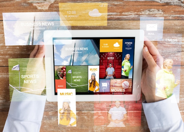 business, mass media, people and technology concept - close up of female hands with news application on tablet pc computer screen