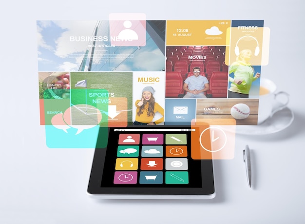 business, media and technology concept - tablet pc computer with application icons and cup of coffee