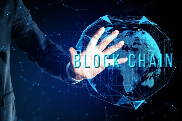 Business person interacting with blockchain technology hologram over a digital global network background