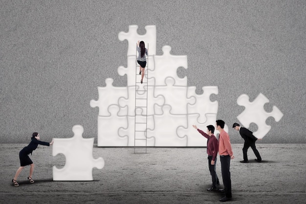 Business team build puzzle together
