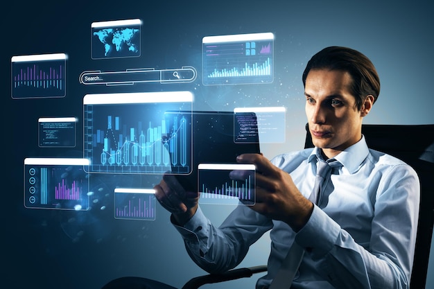 Businessman analyzing financial data on tablet with digital charts and graphs surrounding him on a technologydriven background