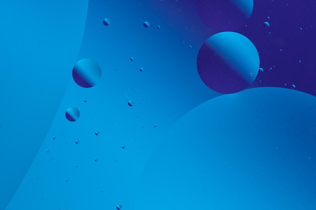 calm and minimalistic abstract design with blue and purple bubbles different sizes on dark blue background