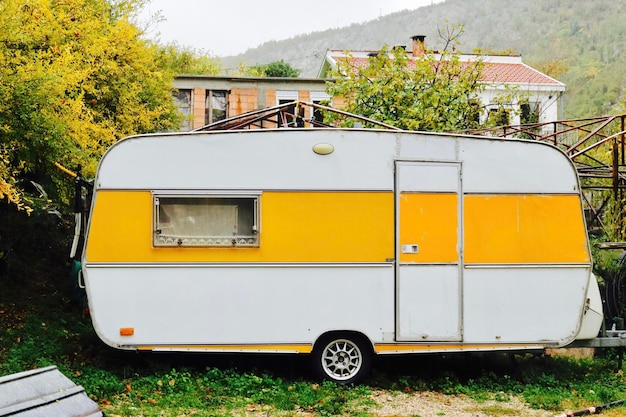 Camper trailer on field by plants