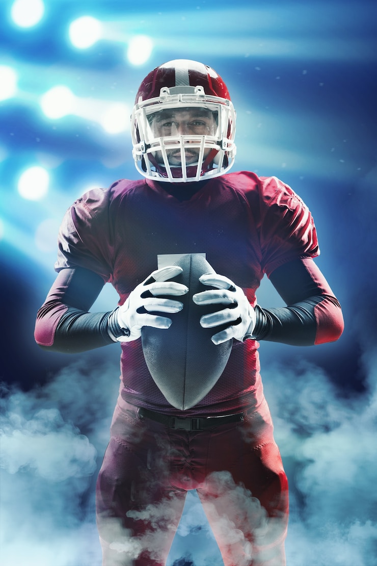 Foto caucasian fitness man as american football player holding a ball on stadium background