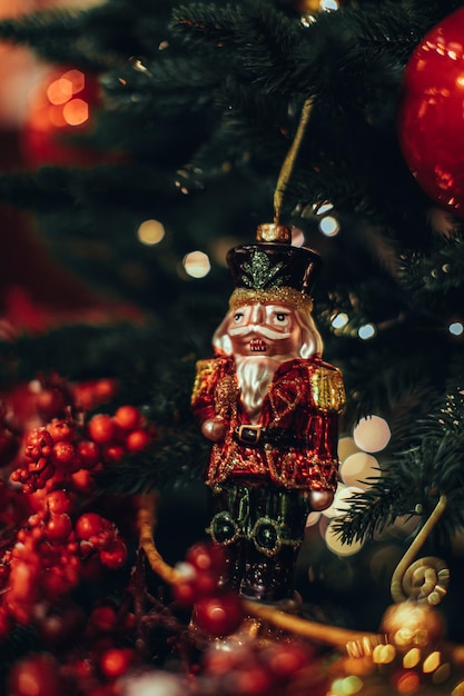 Christmas toy nutcracker hanging on the christmas tree festive decor new year details