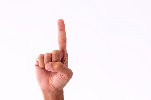 close up mans hand showing gesture of number one on a white background