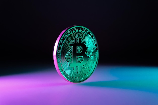 close up of a Bitcoin token with pink and green modern colors BTC crypto Coin detail