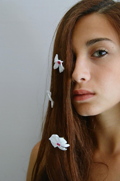 Close-up of beautiful young woman over white background