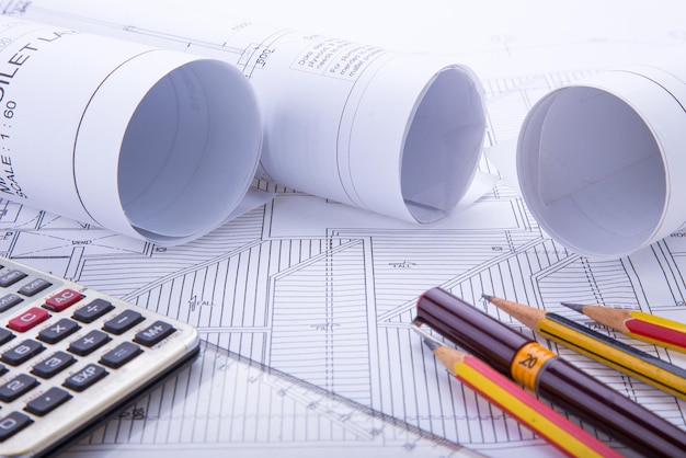 Close-up of blueprint and pencils