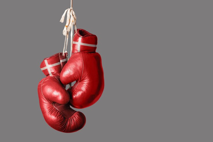 Foto close-up of boxing gloves against gray background