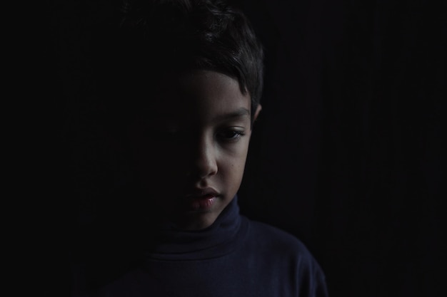 Close-up of boy in darkroom