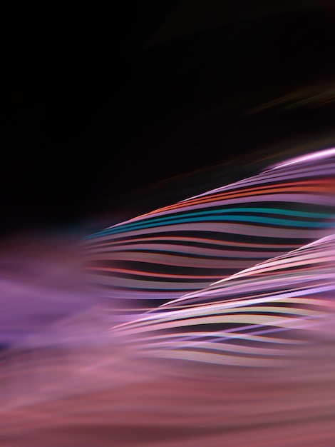 close-up of colorful light trails against black background