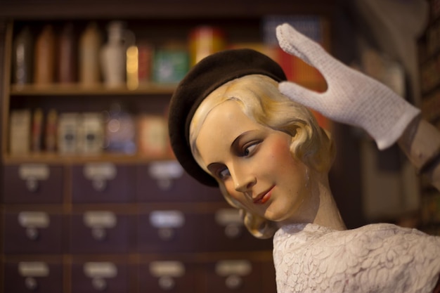 Close-up of female mannequin with glove and hat at store