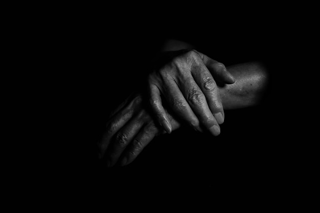 Close-up of human hands over black background