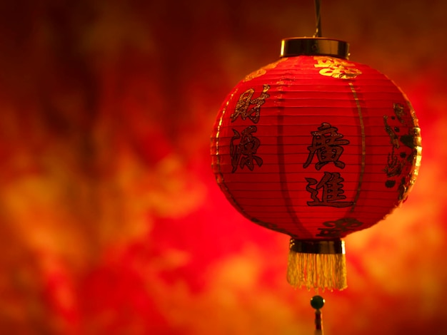 Close-up of illuminated lantern hanging against wall