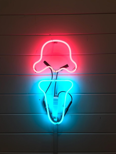 Close-up of illuminated light bulb against wall