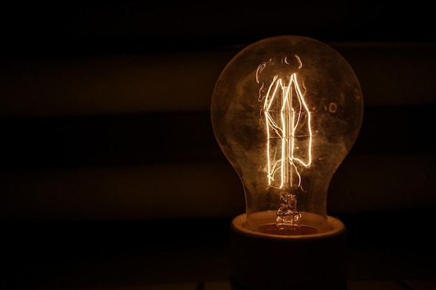 Close-up of illuminated light bulb in darkroom
