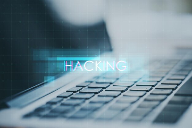close up of laptop with creative digital text hologram on blurry background hacking technology and ai concept