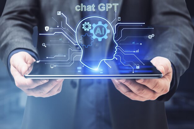 Close up of male hand holding tablet with glowing head outline on blurry office interior background AI and chart GPT concept Double exposure