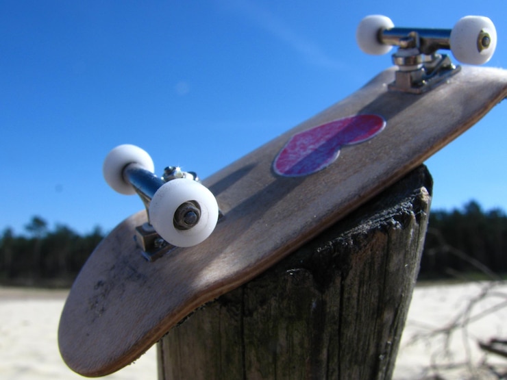 Foto close-up of skateboard upside down on tree stump