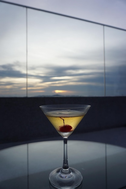 Close-up of wine glass against sunset sky