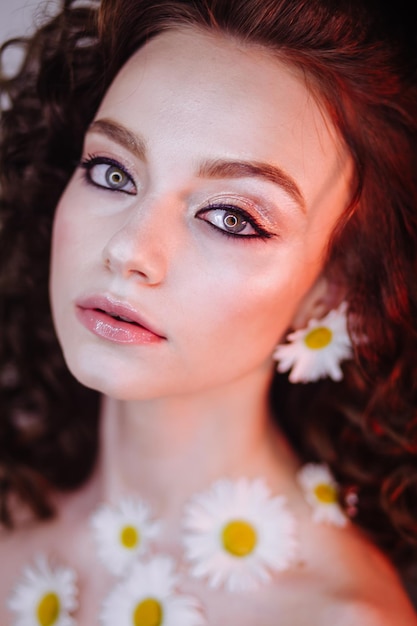 close-up portrait of beautiful young woman wearing flowers and make-up