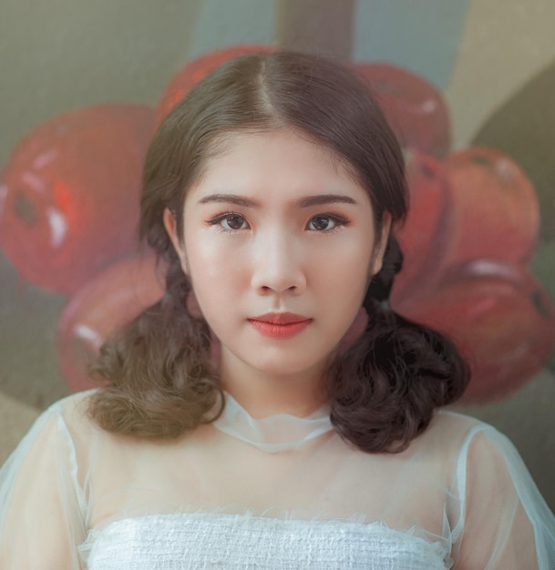 Close-up portrait of young woman with pigtails