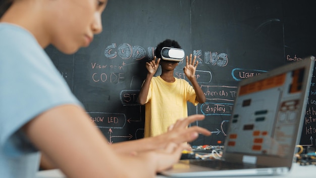 Closeup of school girl hand coding program while student using vr edification