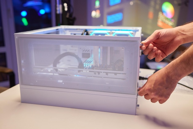 Closeup of technician's hand assembling personal computer