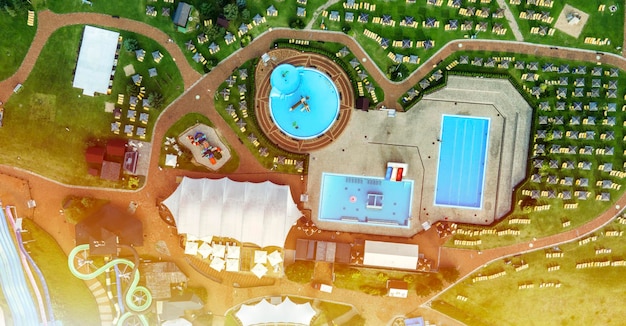 colourful plastic slides in aquapark sliders with pool enjoying summer vacation in water park aerial view of aqua parkbeach umbrellas